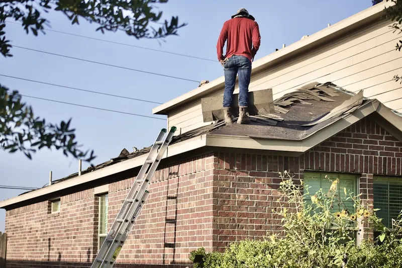 Professional roofer working on a residential roof in Cluster Springs